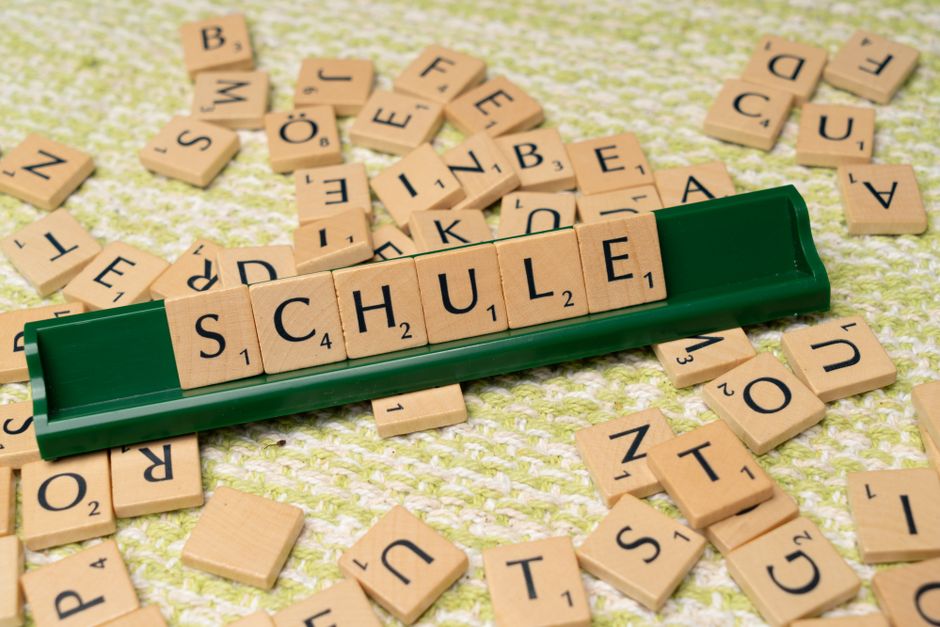 pexels-photo-18512802-18512802-1 Word tiles spelling 'Schule' on table, ideal for language learning concepts.