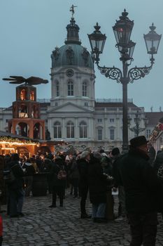 Crowd enjoying a winter market at Charlottenburg Palace, Berlin.