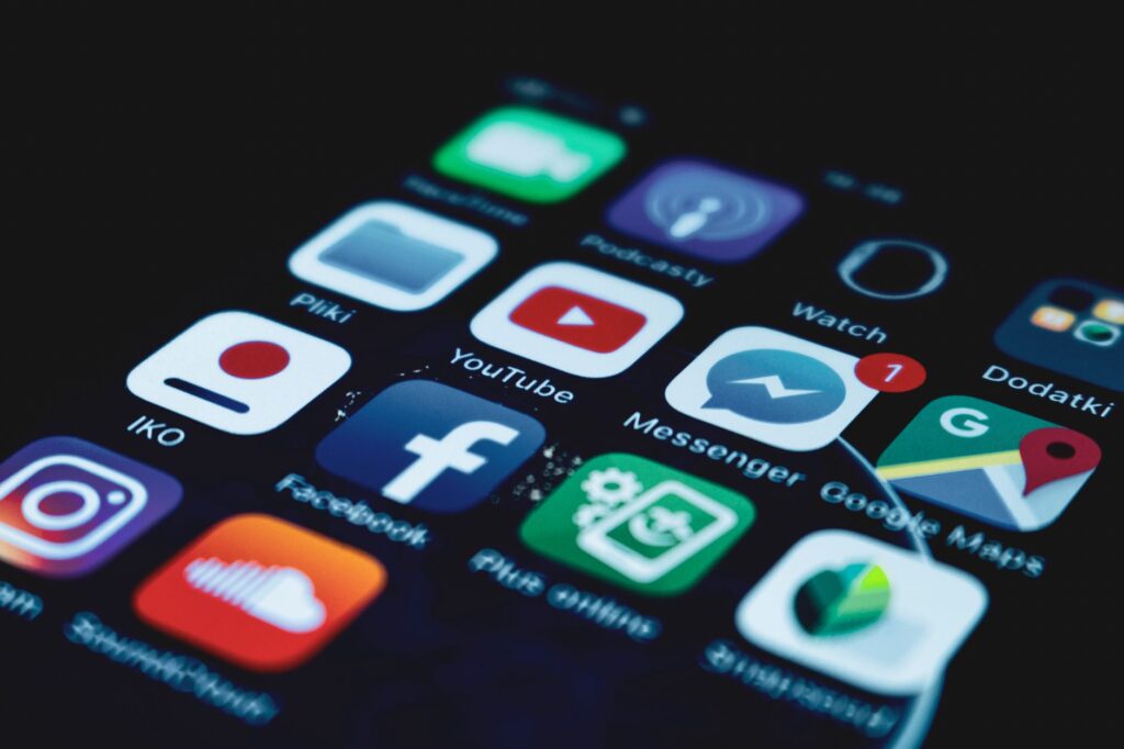 pexels-photo-5956083-5956083 Detailed close-up view of a smartphone screen displaying various popular social media app icons.